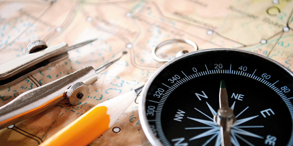 Conceptual,Image,Of,A,Magnetic,Compass,And,Pencil,Lying,On